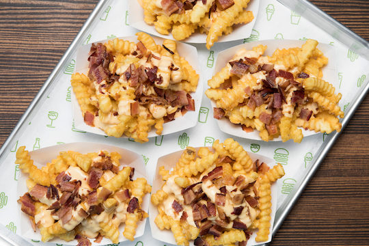 bacon cheese fries grouped together on a serving tray