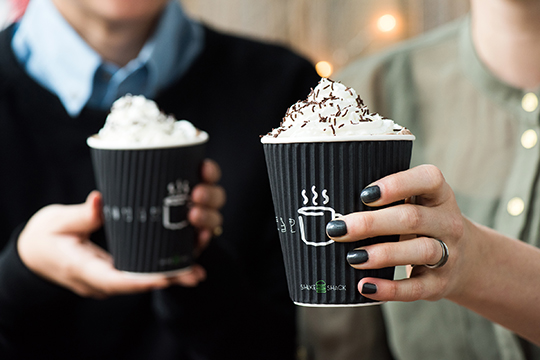 two Brownie Batter Hot Chocolates being held in hands