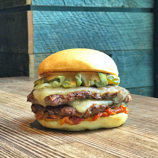 double cheddar cheeseburger with anchovy 'Gochu jang' paste, 'Doen jang' paprika compote, and fermented cucumber pickles