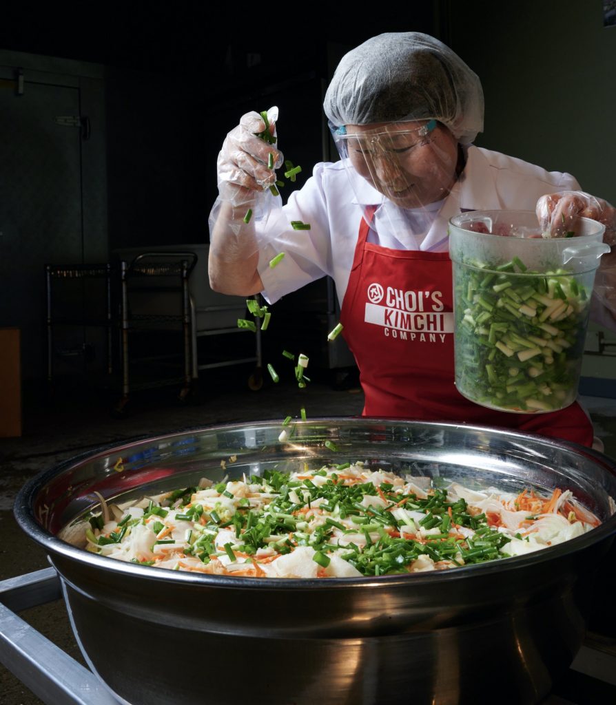 Preparing kimchee in a large bowl