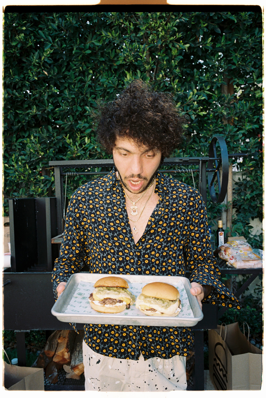 Benny Blanco holding tray of burgers