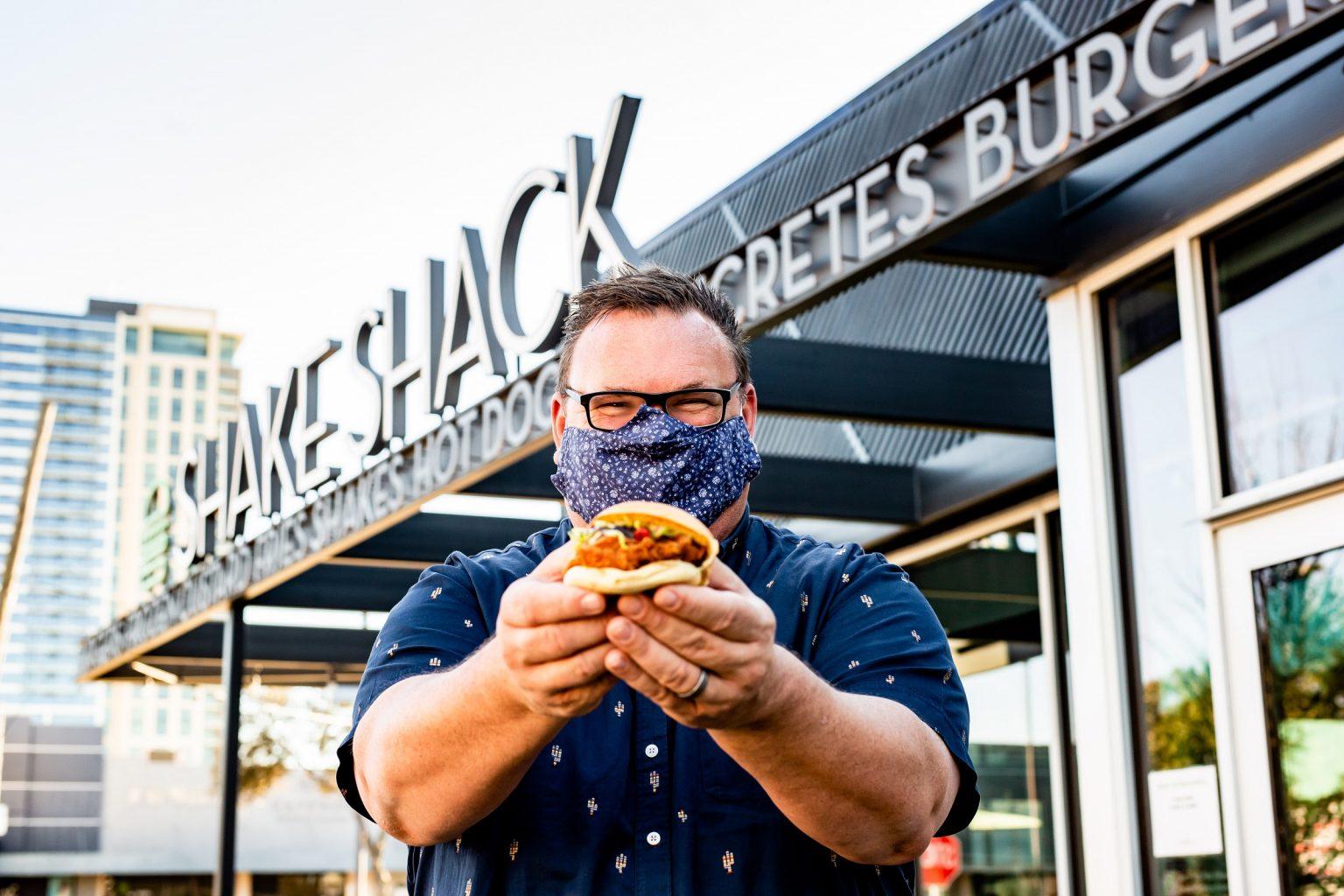 Chris Shepherd holding a burger