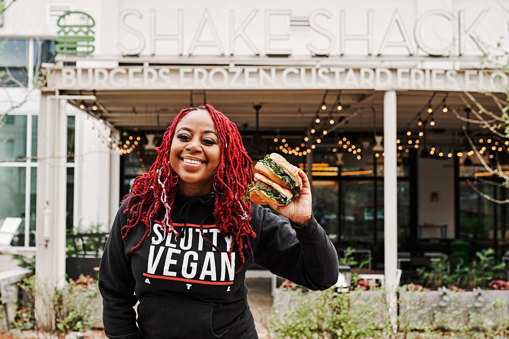 Pinky Cole holding a burger