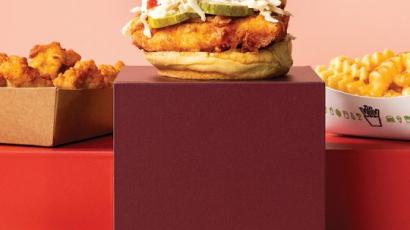 chicken sandwich, fries, and nuggets on boxes of different heights.