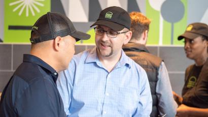 Shake Shack manager and employee talking inside store