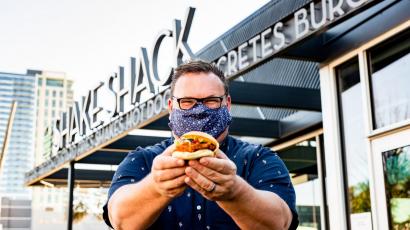 Chris Shepherd holding a burger