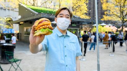 Junghyun Park holding Atoboy shrimp burger