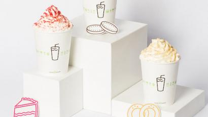 three shakes with different toppings, each sitting on a box of a different height