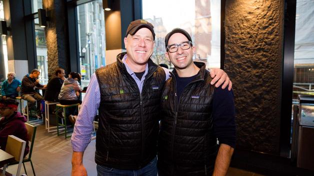 Two Shake Shack employees with their arms around each other