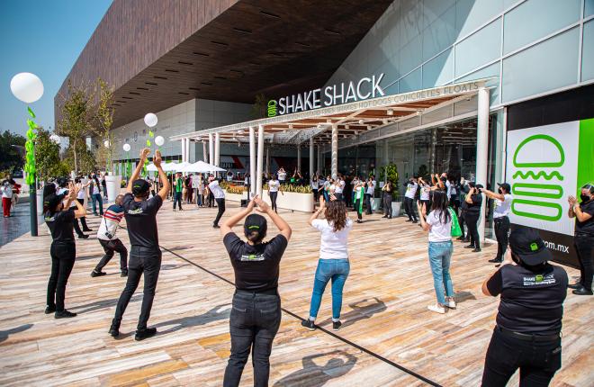 Employees clapping outside of Shake Shack
