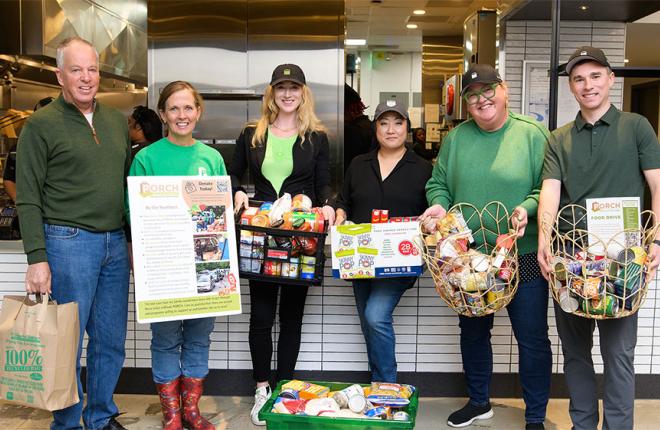 team members with baskets of donated food
