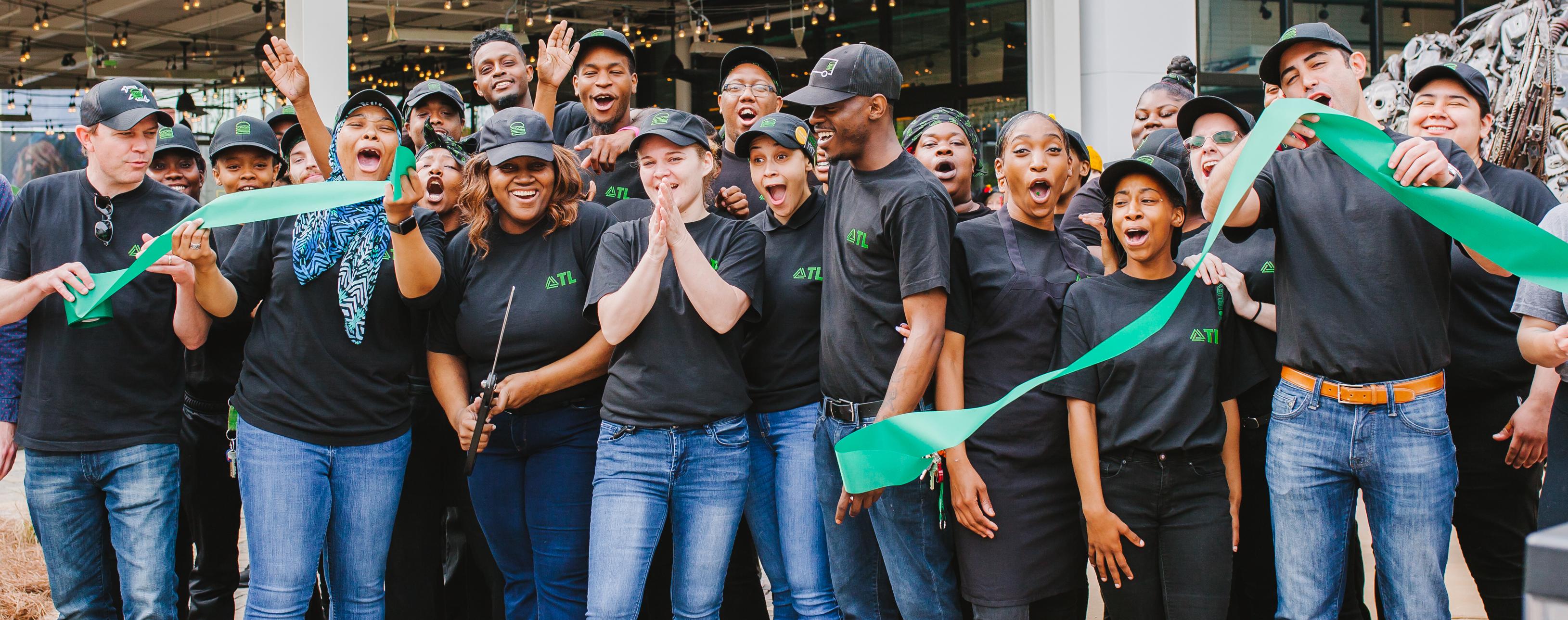 group of Shake Shack employees outside during a ribbon cutting ceremony