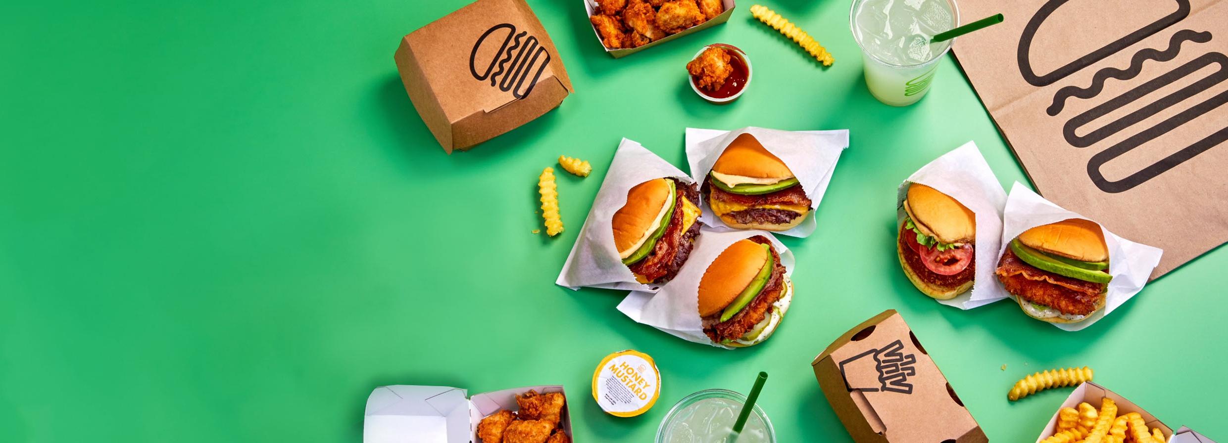 Homepage Group of food on green background with delivery packaging